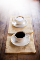 Two cups of coffee on brown napkin