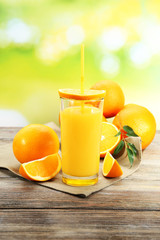 Glass of orange juice with straw and slices