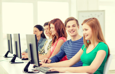 smiling student with computer studying at school