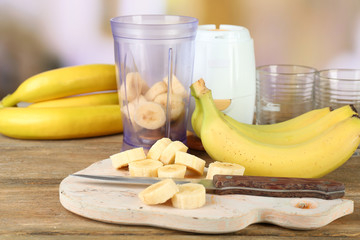 Sliced banana on cutting board, on wooden background