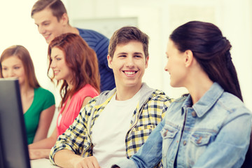 Fototapeta premium smiling students in computer class at school