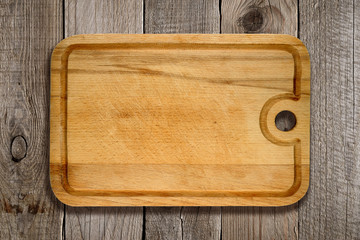 Cutting board on old wooden background