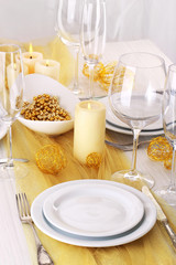 Beautiful holiday table setting in white and gold color