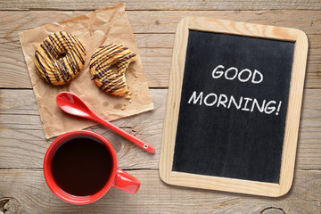 Coffee cup, cookies and blackboard with Good morning! phrase