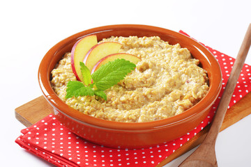 Oatmeal porridge with sliced apple