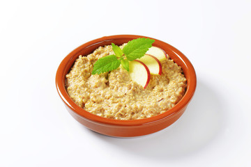 Oatmeal porridge with sliced apple