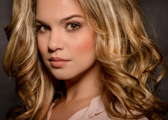 Fototapeta premium Blonde with a stylish haircut and styling on a dark background