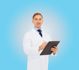 Naklejka na ściany i meble smiling male doctor with clipboard