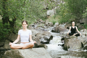 Woman and man doing yoga in nature