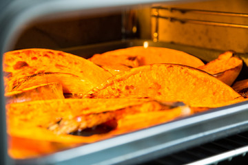 Roasted pumpkin on a baking tray in oven