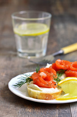 Canape with homemade salted salmon and curd.