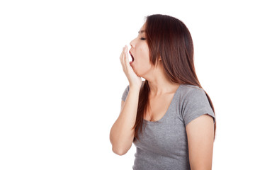 Fototapeta premium Sleepy young Asian woman yawn