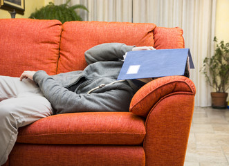 Young man at home sleeping instead of working or studying