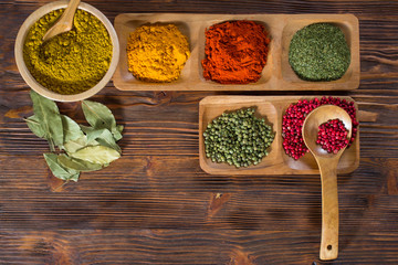 Colorful herbs,spices and aromatic ingredients  on wooden table.