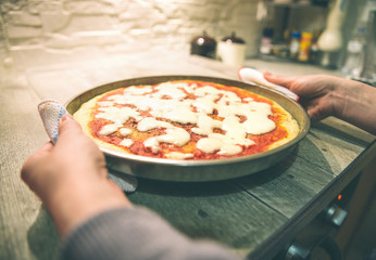 Woman cooks pizza at home