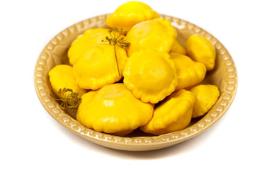 Pickled Pattypan Squash on white background. Selective focus.