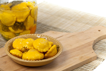 Pickled Yellow Pattypan Squash. Selective focus.