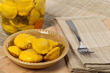 Pickled Yellow Pattypan Squash. Selective focus.