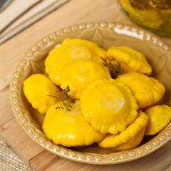 Pickled Yellow Pattypan Squash. Selective focus.