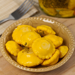 Pickled Yellow Pattypan Squash. Selective focus.