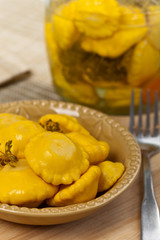 Pickled Yellow Pattypan Squash. Selective focus.