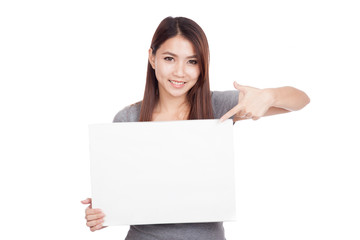 Naklejka premium Young Asian woman point to blank sign