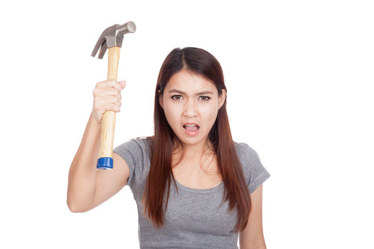 Angry young Asian woman with hammer