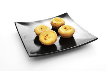 Egg tarts on black plate