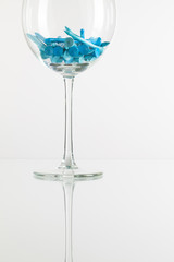 Glass of wine and golf equipments