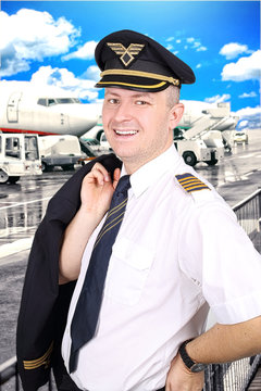 Elegant smiling pilot at the airport in beautiful day