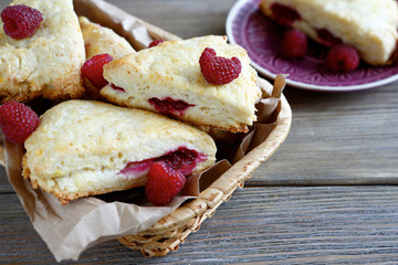 Scone with raspberry in a wicker basket
