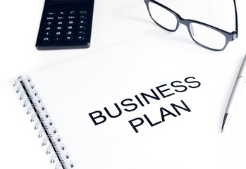 business plan words near calculator, glasses and pen