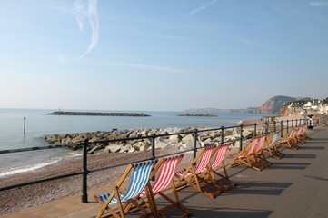 Deckchairs on seafront at Sidmouth in Devon - obrazy, fototapety, plakaty