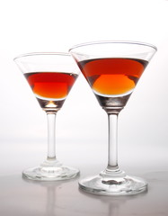Two glasses of cognac isolated on a white background
