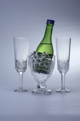 Bottle of shampagne in ice and goblets