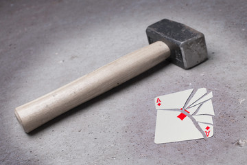 Hammer with a broken card, ace of diamonds