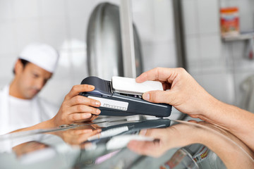 Customer Paying Through Smartphone In Butchery