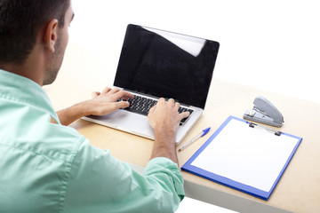 Young man with a laptop at his desk