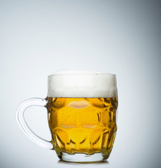 Mug full of fresh beer isolated on white