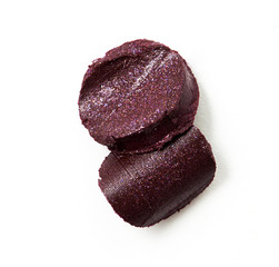 Purple color lipstick cut on white paper