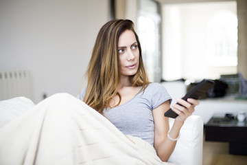 Young woman with remote control