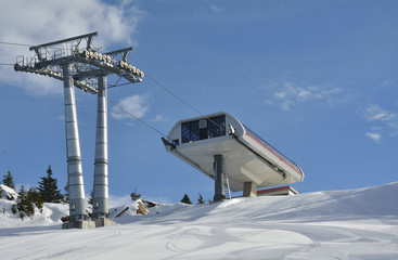 Fototapeta premium Ropeway in snow mountain under blue sky