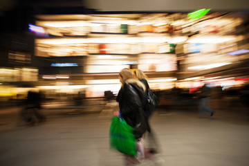 Fototapeta premium Two young women shopping in the city at dusk