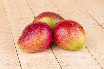 Close up of ripe mango on the wooden table.