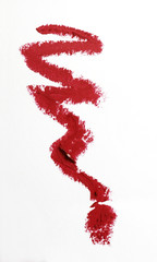 Red color lipstick stroke on white paper