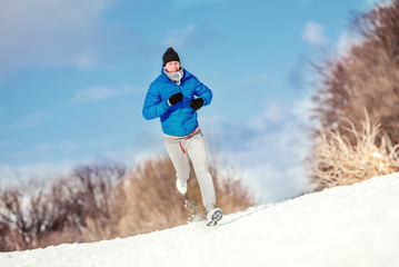 Athlete running on snow, preparing for hard training