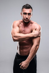Fototapeta premium Portrait of a muscular man touching his shoulder