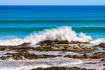 Waves crashing onto the coastal rocks
