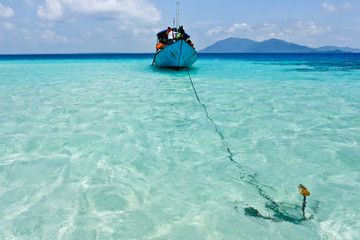 Boat with anchor in tropical ocean near Karimunjawa side view