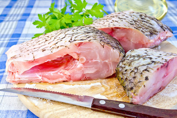 Bream raw with parsley on fabric